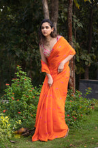 Vaishnavi saree – hand-embroidered orange silk organza drape paired with a contrast pink blouse, inspired by the hues of nature